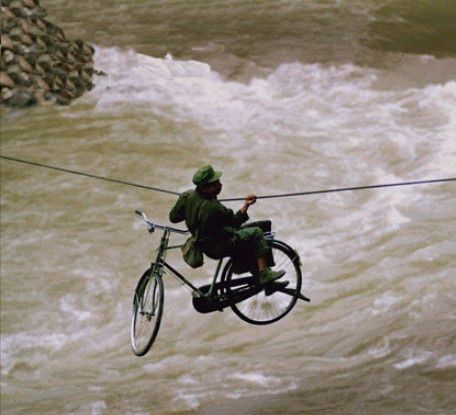 bicyclerivercrossingbyropebridge.jpg ht=415