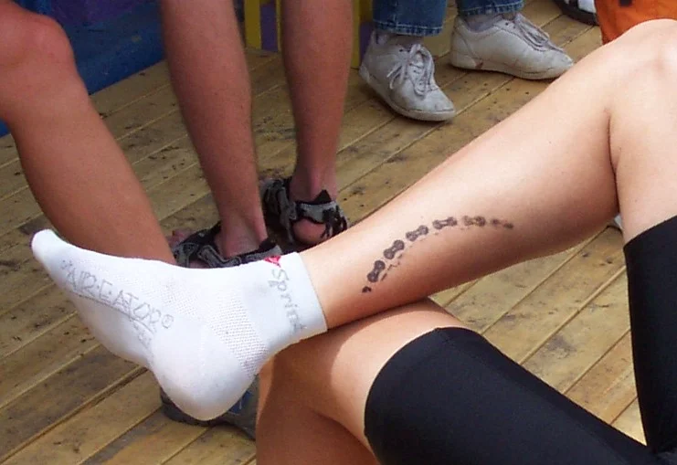 cycle-chain-ring-tattoo-on-leg.webp