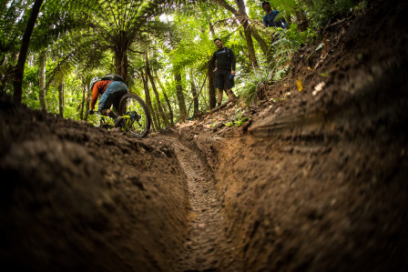 Jag droppar in i en av banans många branta, leriga kurvor. Foto: Lee Trumpore